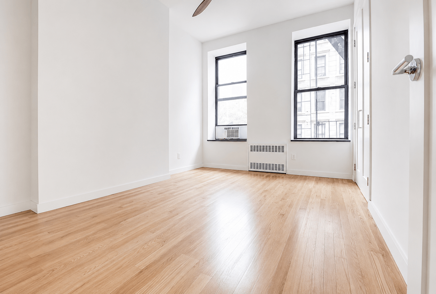 A room with wooden floors and white walls.